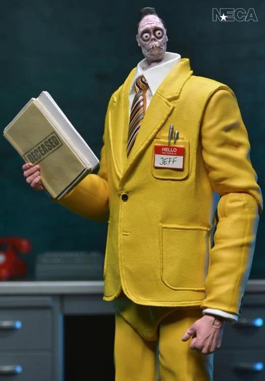 Figura completa de Jeff posando con las manos en los bolsillos del saco.