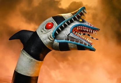 Beetlejuice y el Sandworm enfrentados en una toma de ángulo bajo para resaltar la escala.